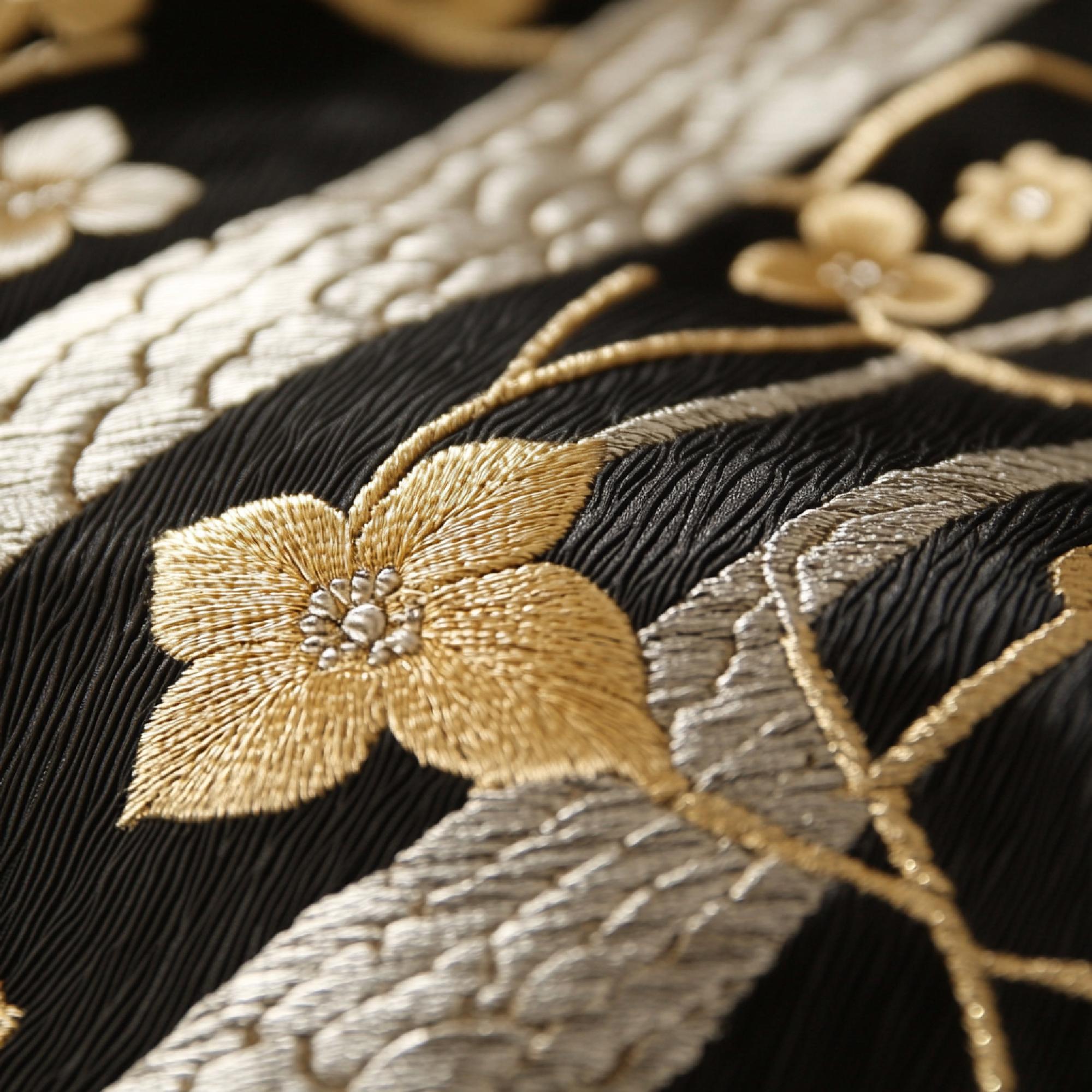 Close-up of gilded thread embroidery on linen